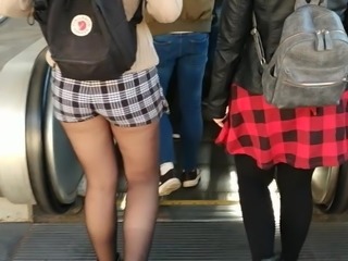 Black pantyhose and shorts on the escalator